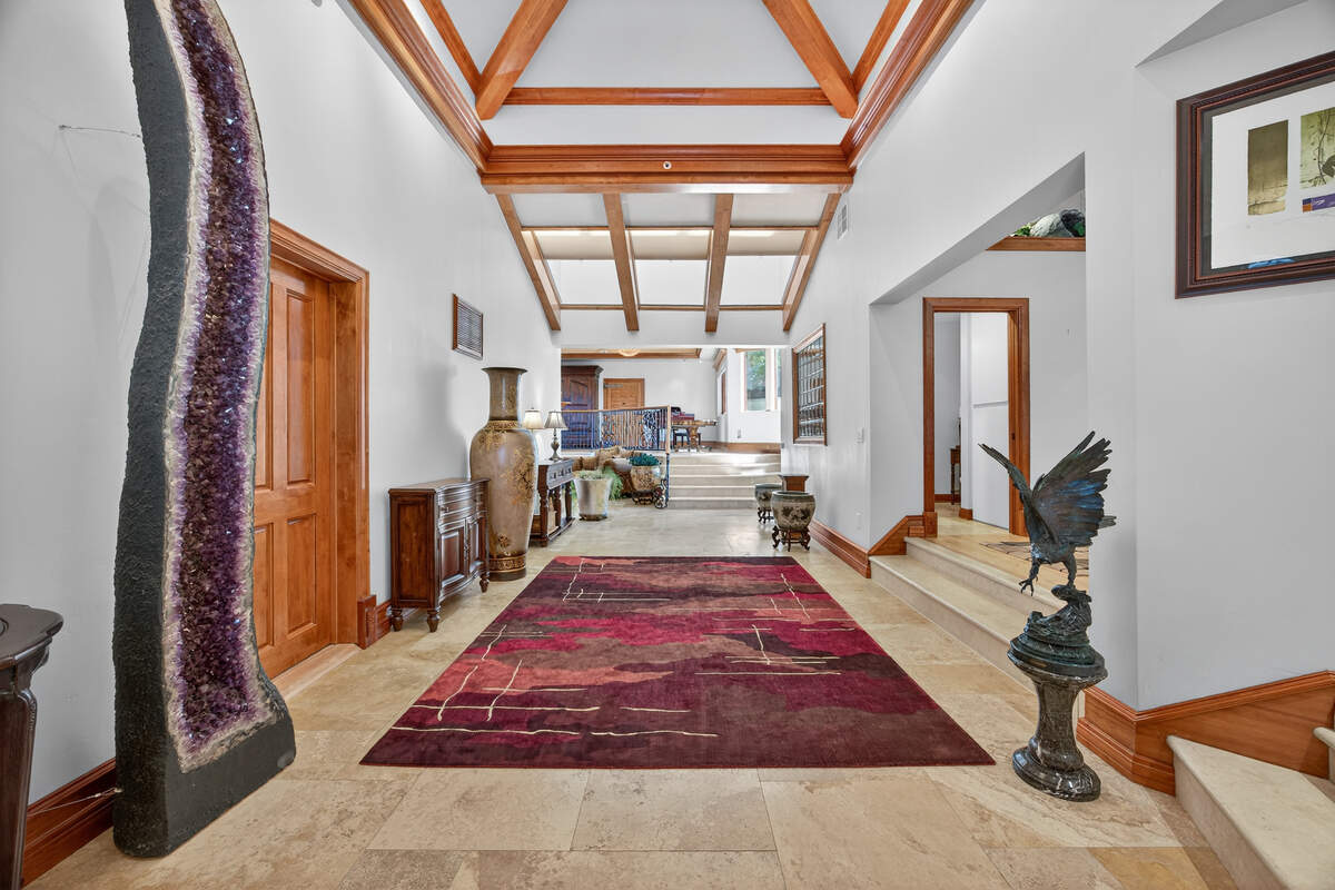 An art gallery forms the connecting hallway between the original 1974 cabin and the newer sections of the main residence, linking the property’s early construction with its later expansion.